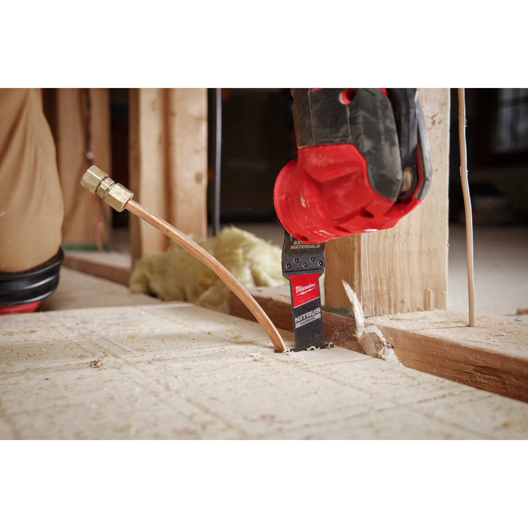 Worker using the NITRUS CARBIDE Extreme Materials Universal Fit OPEN-LOK Multi-Tool Blade to cut through plywood