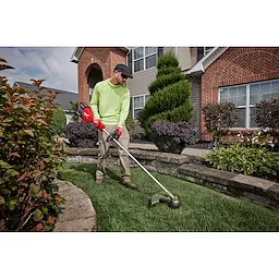 Image of a worker using the Milwaukee M18 FUEL 17” Dual Battery String Trimmer