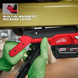 Image of a worker using the Milwaukee M18 Magnetic Extendable Boom Light on a jobsite with the text "Built-In Magnetic Release Lever"