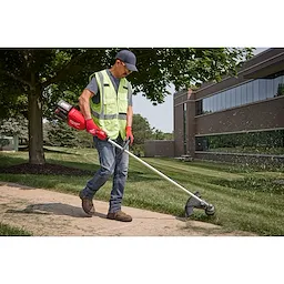 Image of a worker using the Milwaukee M18 FUEL 17” Dual Battery String Trimmer