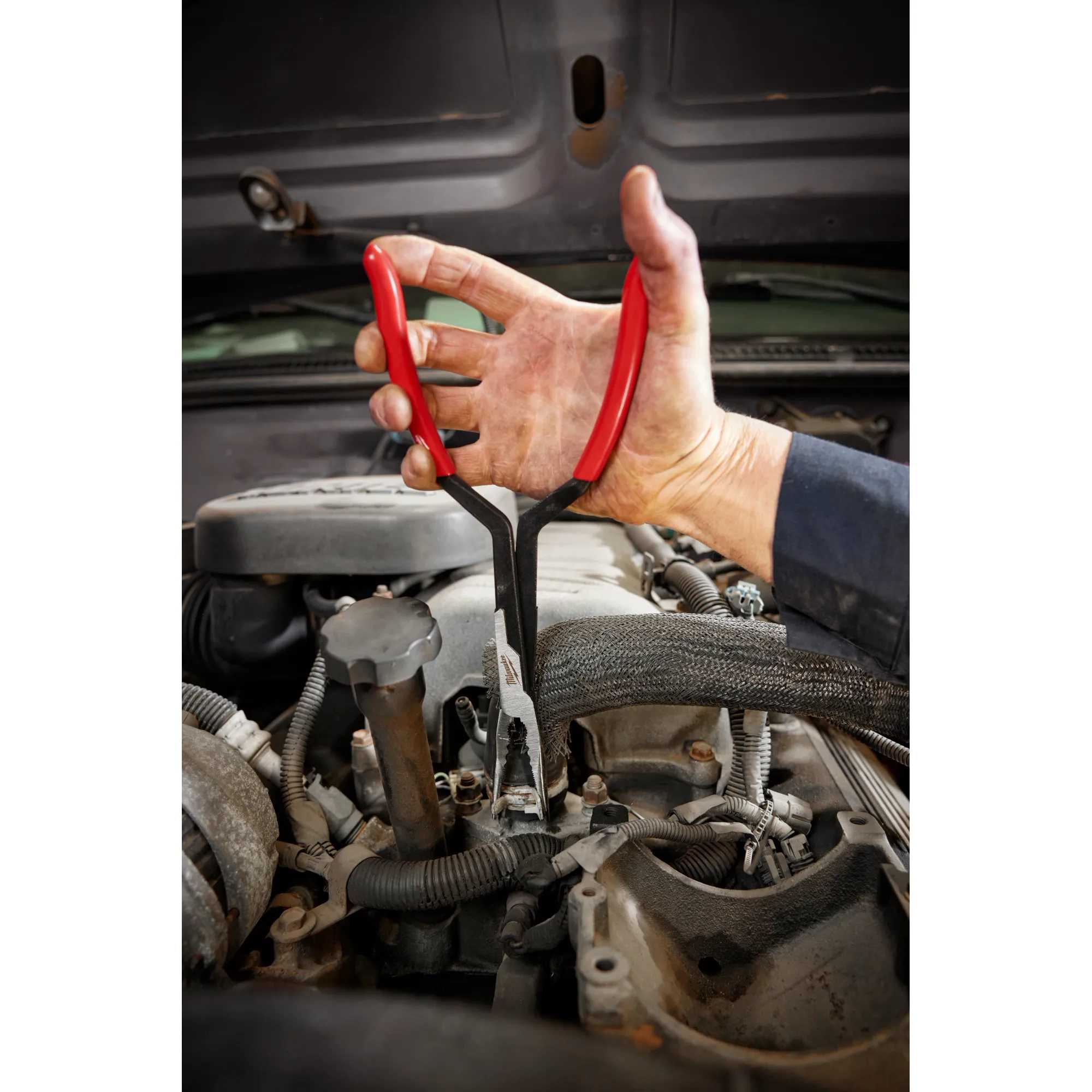 Worker using the 13” Long Reach Pliers