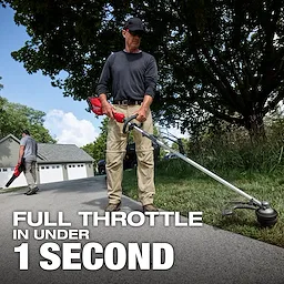 A person uses the M18 FUEL™ String Trimmer w/ QUIK-LOK™ Kit on a driveway, with bold text stating "FULL THROTTLE IN UNDER 1 SECOND" in the foreground, and another person using a blower in the background near a grey garage. Surrounding greenery and trees are visible.