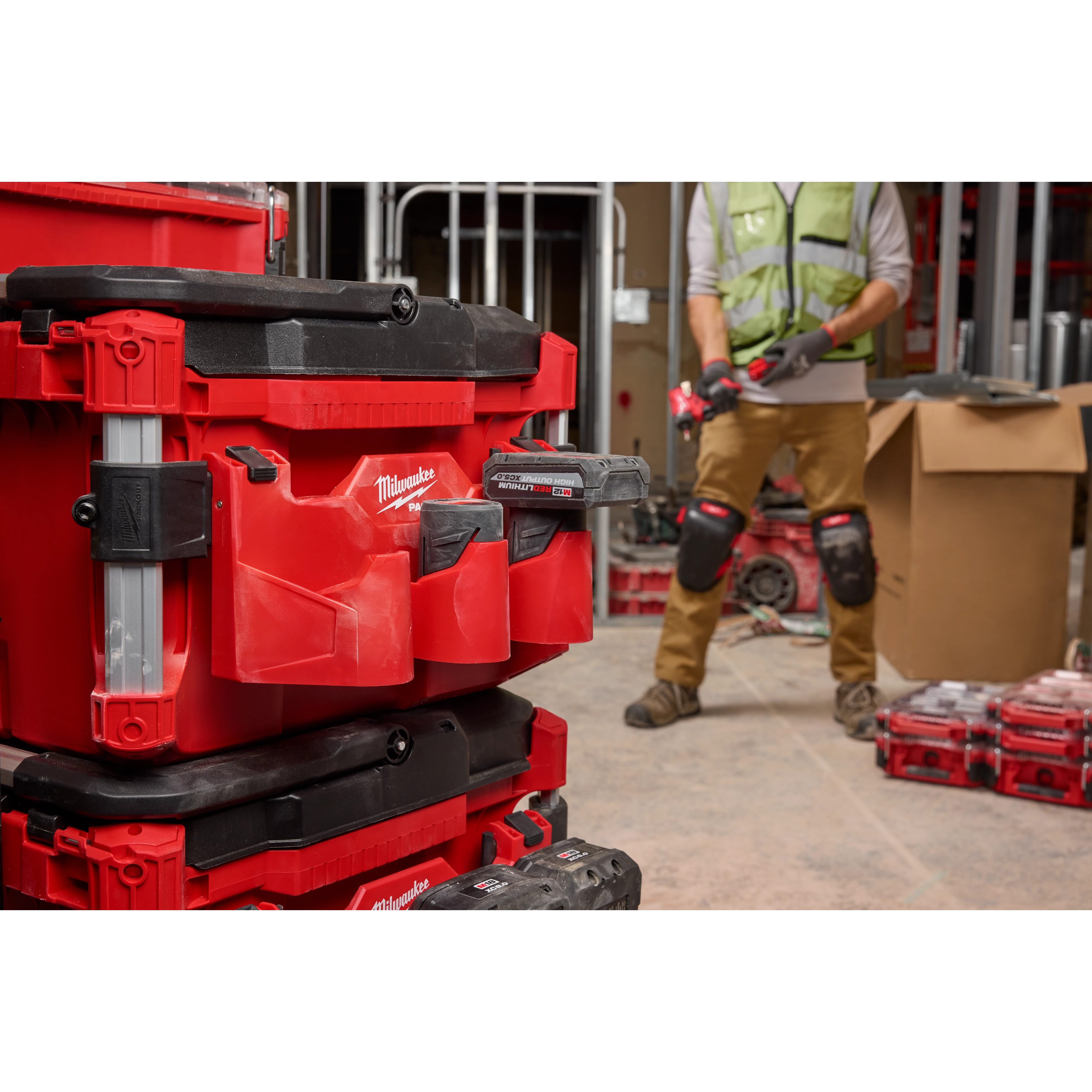 Red PACKOUT Tool Box with a M12 Battery Rack Attachment mounted on its side