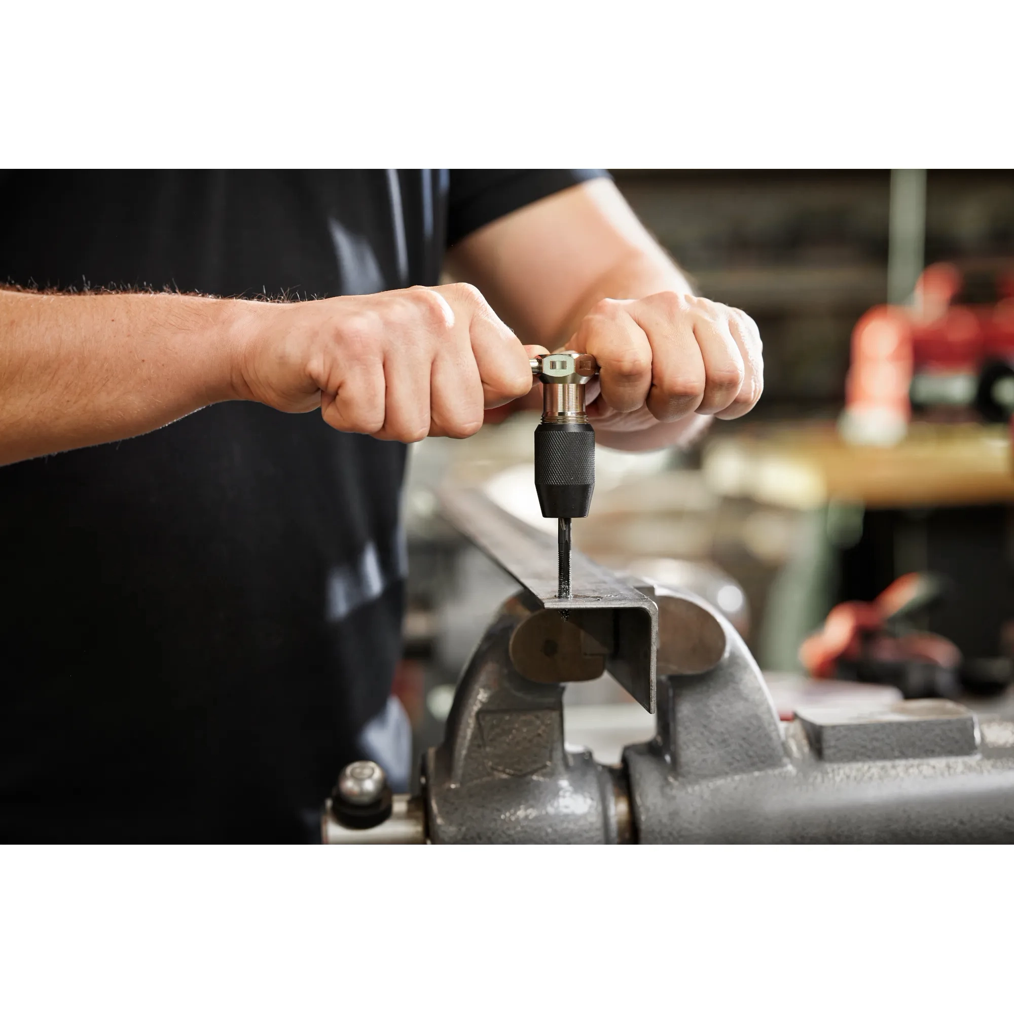 Worker using the Tap Collet for Taps up to 1/2” & T Handle Bar