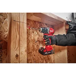 Worker using the  Compact Brushless 1/2" Drill/Driver to drill out a hole in wood