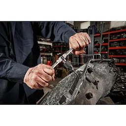 Worker using the Tap Collet for Taps up to 1/2” & T Handle Bar