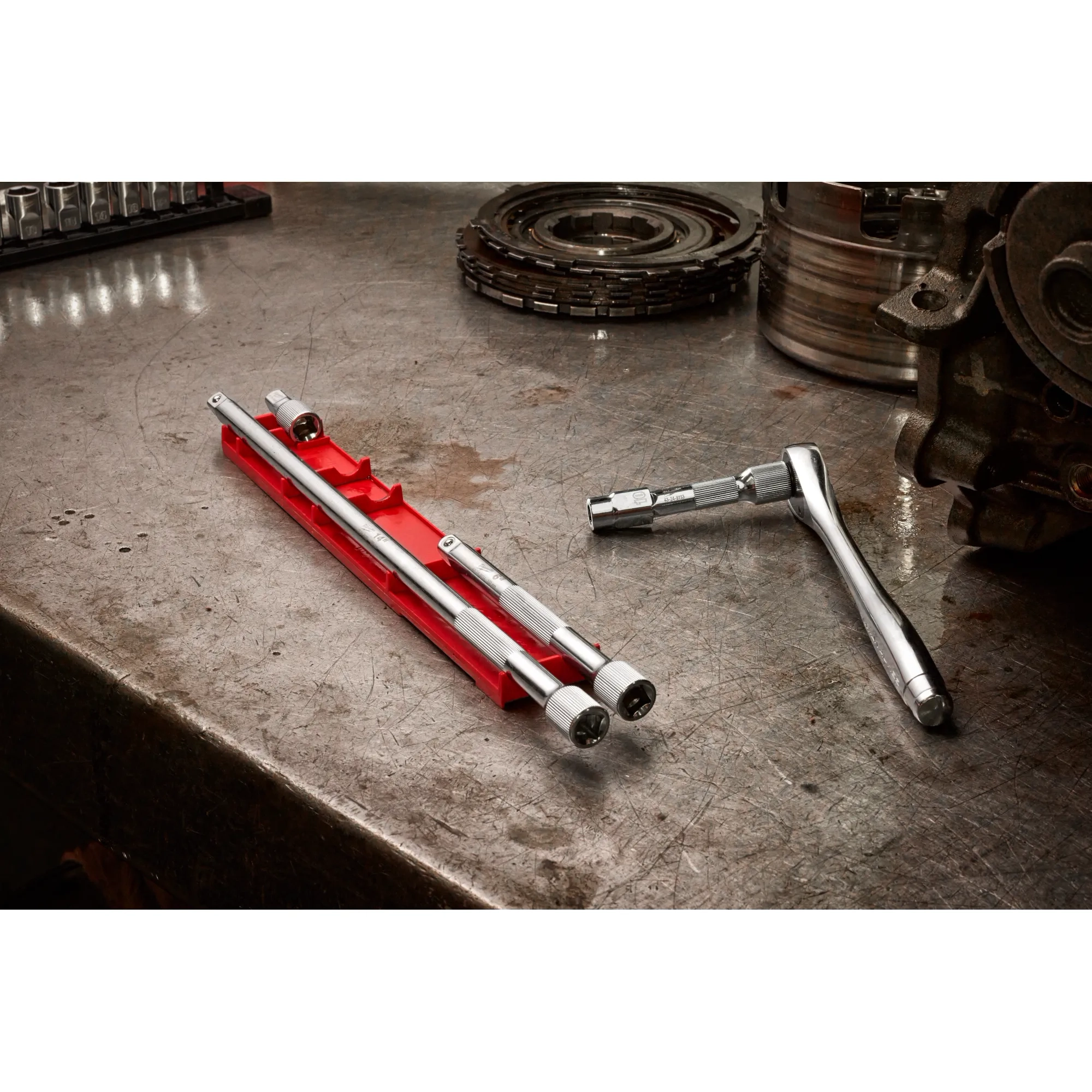 Image of the Milwaukee 4pc 3/8” Drive Extension Set on an autoshop table