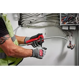 Image of a worker using the Milwaukee Armored Cable Cutter on wiring