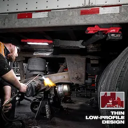 Image of a worker using the Milwaukee M18 Magnetic Extendable Boom Light on a jobsite with the text "Thin Low-Profile Design"