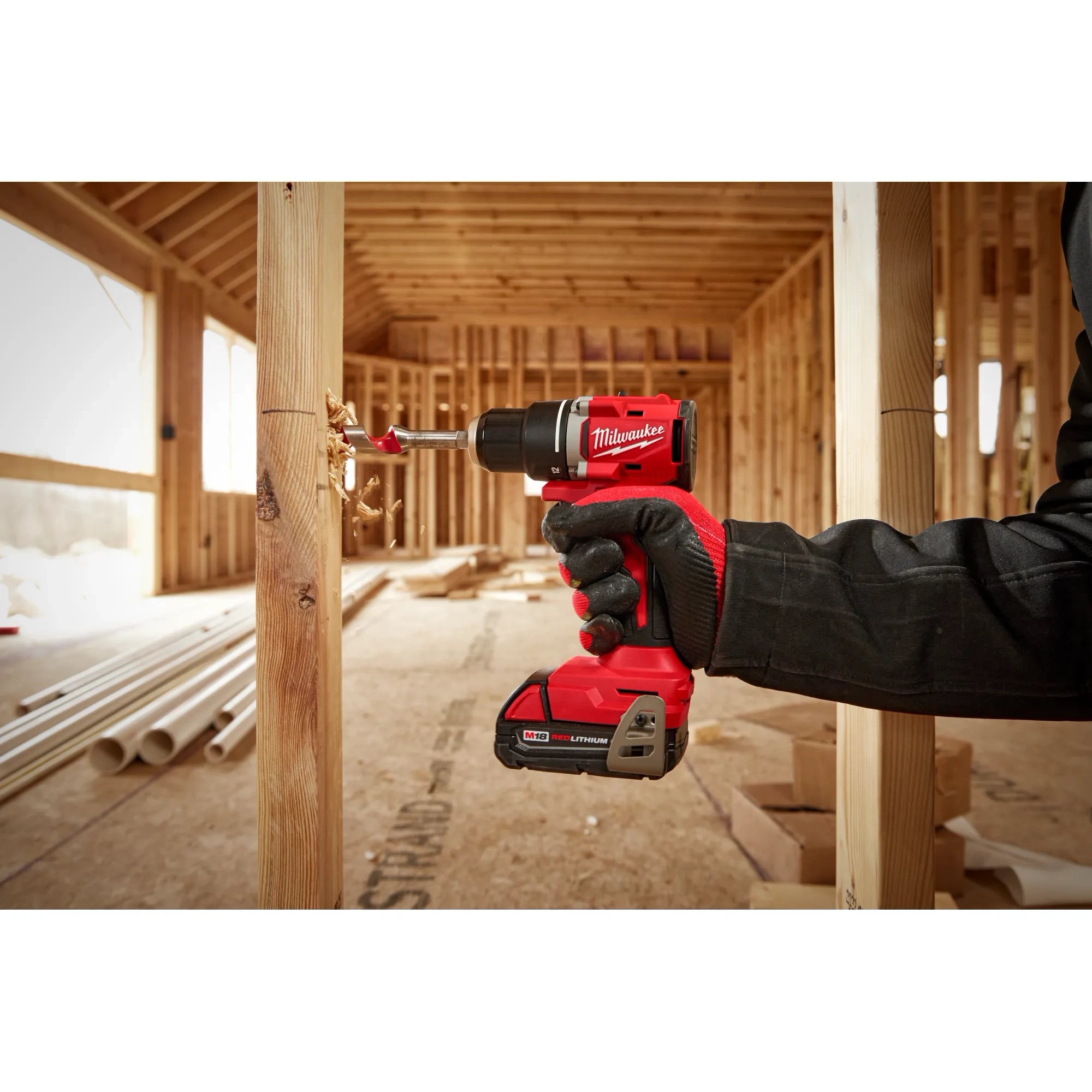 Worker using the Compact Brushless 1/2" Drill/Driver to drill out a hole in wood