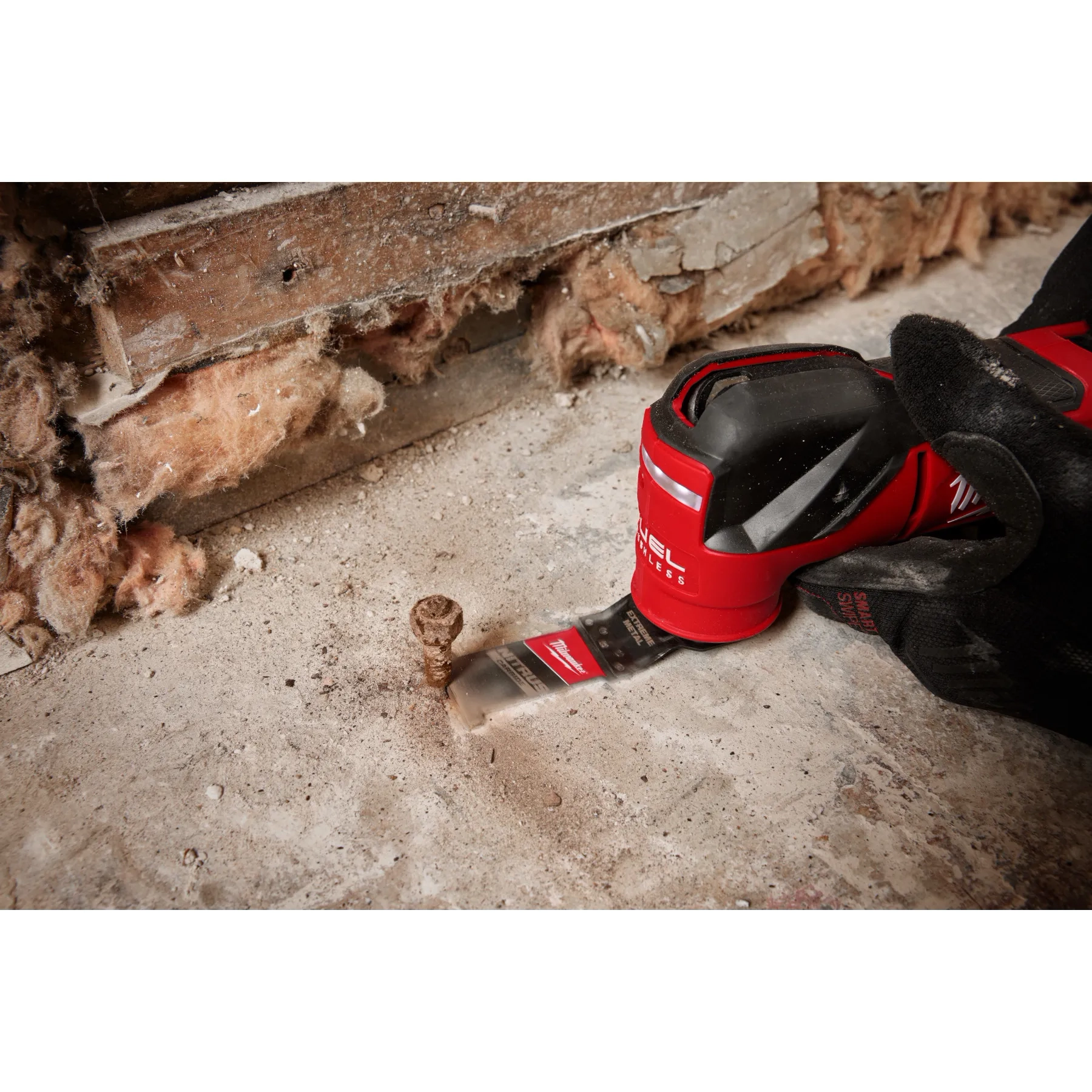 Worker using the NITRUS CARBIDE Extreme Metal Universal Fit OPEN-LOK Multi-Tool Blade to cut through a rusted bolt screw