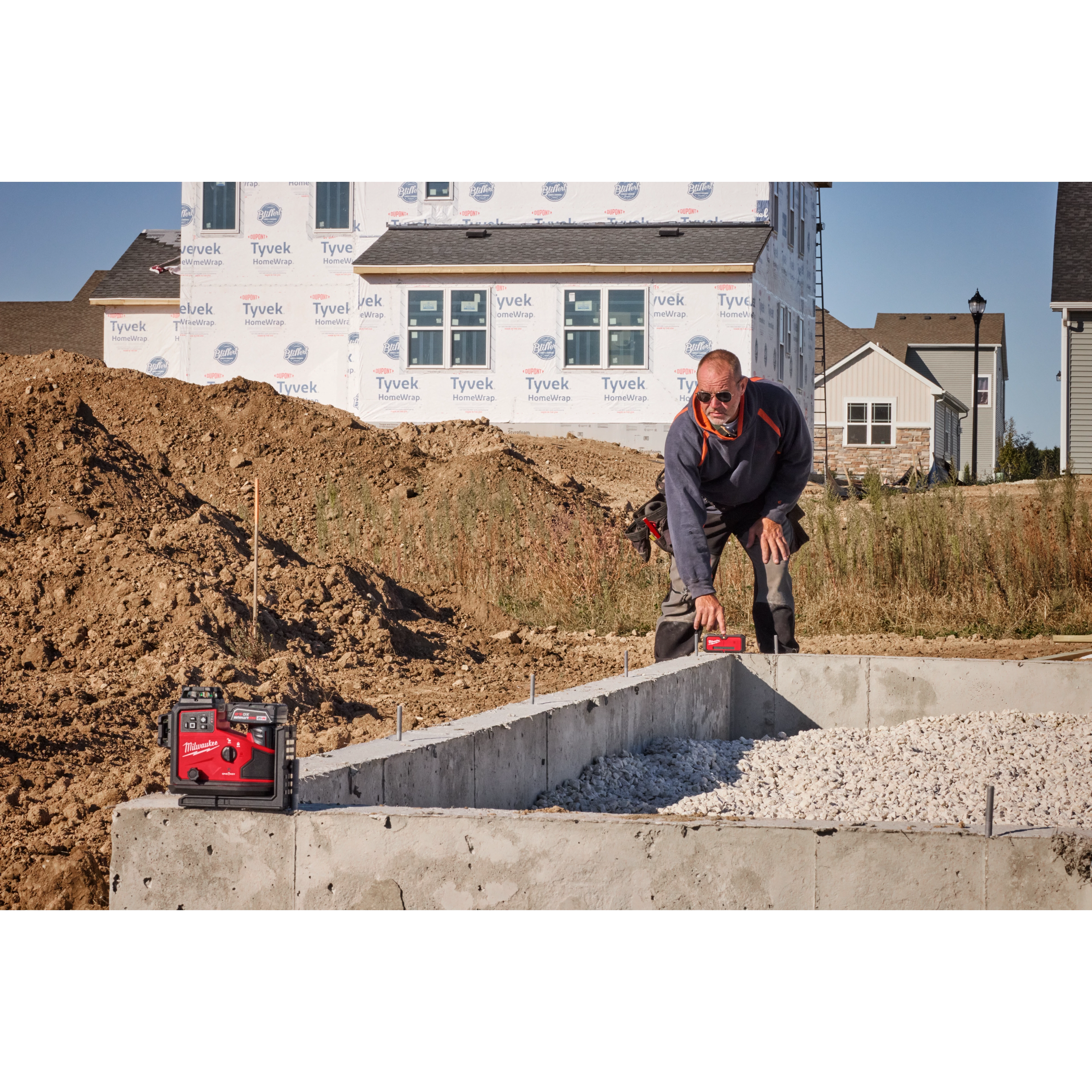 Image of the M12™ Green 360° 3-Plane Laser w/Automatic Alignment & Receiver being used on the jobsite